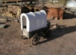 Bluff Fort -- Covered wagon, Barton cabin in the background. Lamont Crabtree Photo 